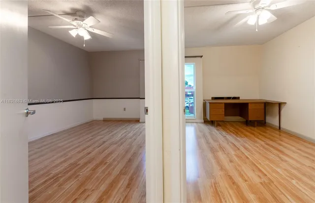 a view of empty room with wooden floor
