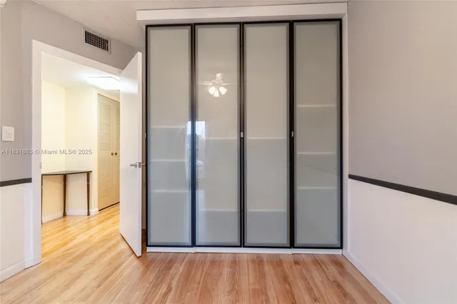 a view of a hallway with wooden floor