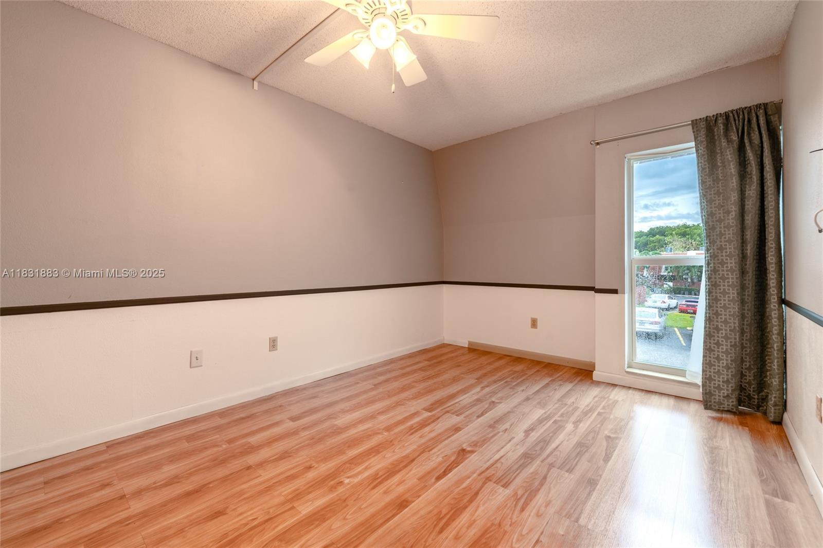 13949 Southwest 84th Street, Unit 801 Miami, FL 33143 - Photo 16 of 38 wooden floor in an empty room with a window