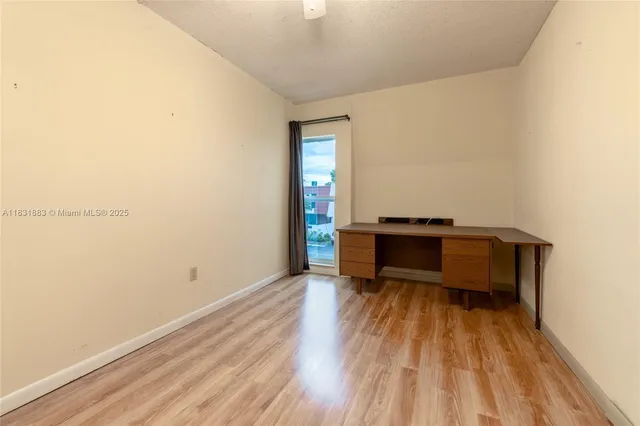 a view of a room with wooden floor and a sink