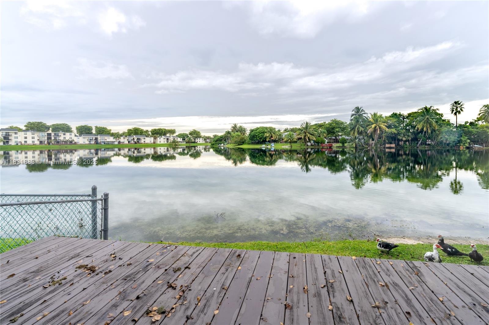 13949 Southwest 84th Street, Unit 801 Miami, FL 33143 - Photo 37 of 38 a view of a deck with sunset view