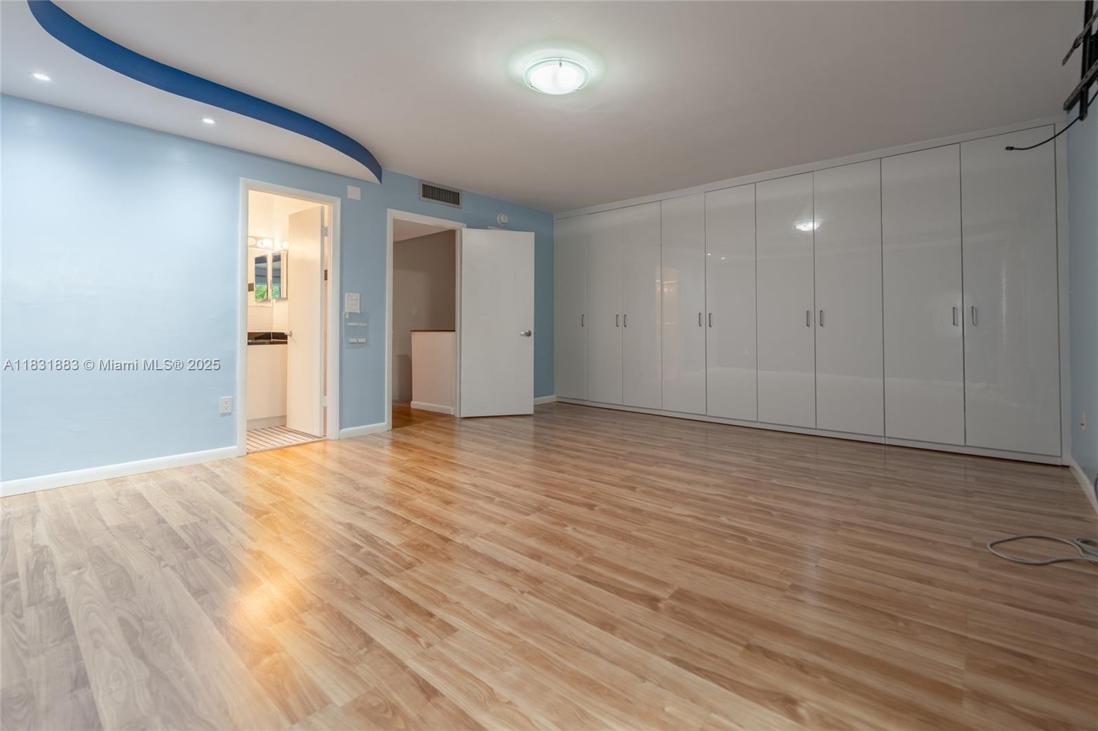 13949 Southwest 84th Street, Unit 801 Miami, FL 33143 - Photo 7 of 38 a view of an empty room with wooden floor and closet