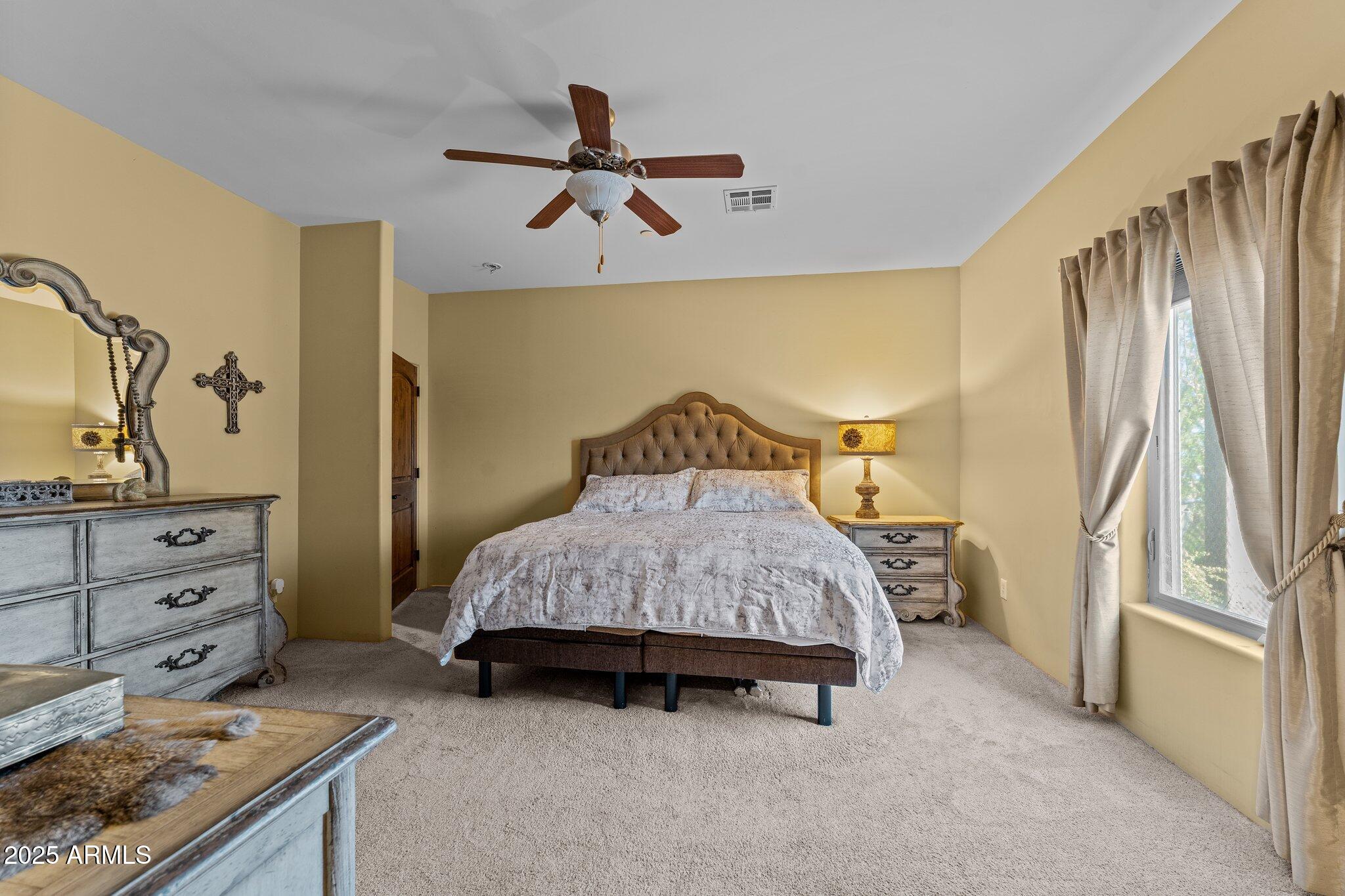 17789 West Peak View Road Surprise, AZ 85387 - Photo 26 of 69 a bedroom with a bed and a dresser