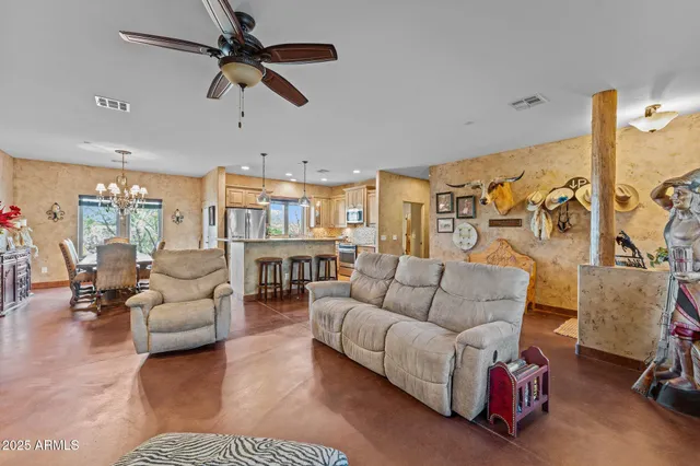a view of a dining room with furniture a chandelier and wooden floor
