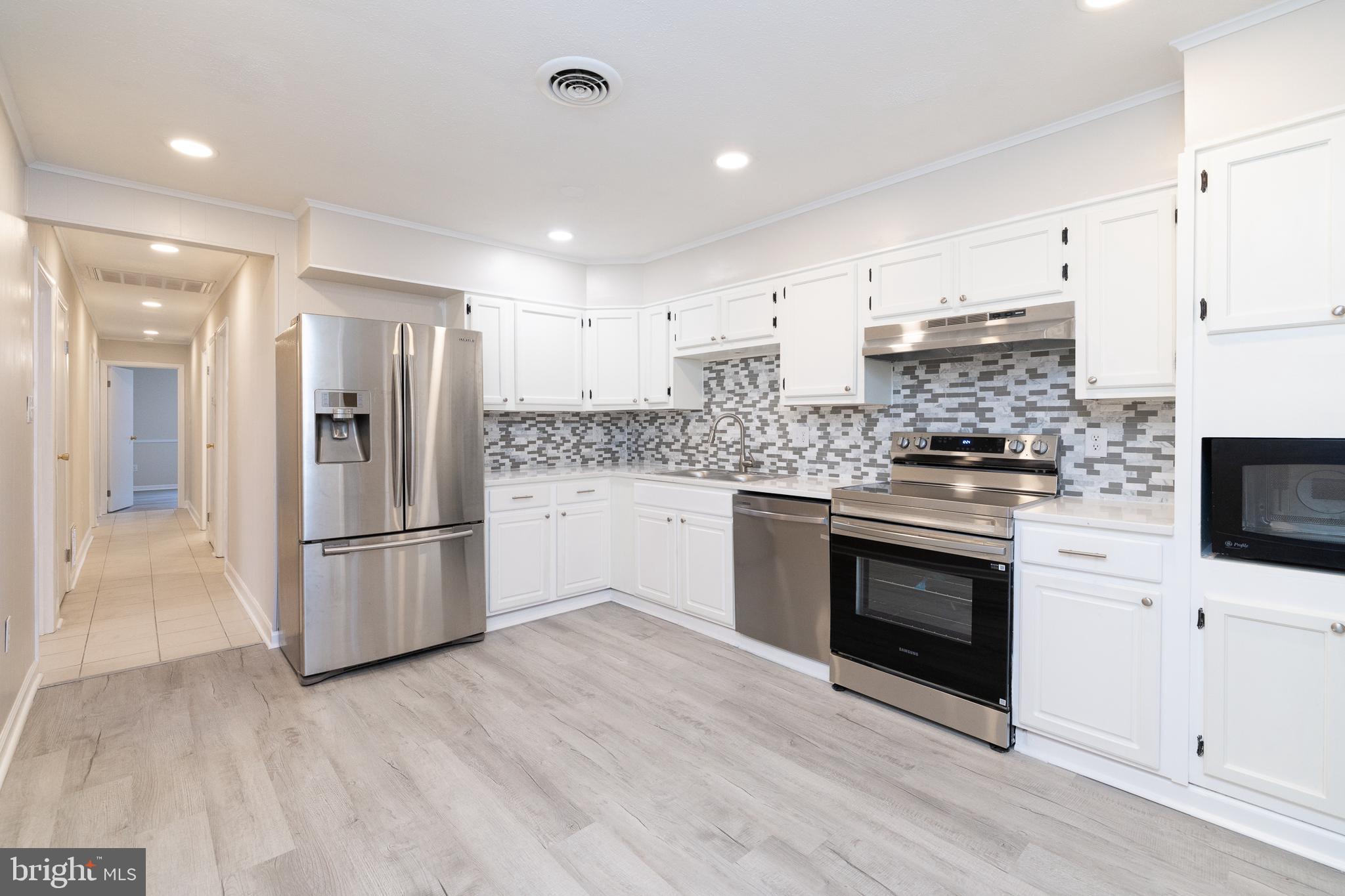 6731 Middle Road Middletown, VA 22645 - Photo 14 of 61 a kitchen with a refrigerator stove and microwave