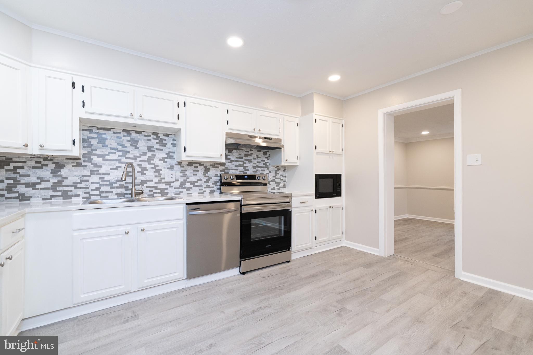 6731 Middle Road Middletown, VA 22645 - Photo 15 of 61 a kitchen with granite countertop white cabinets and white appliances