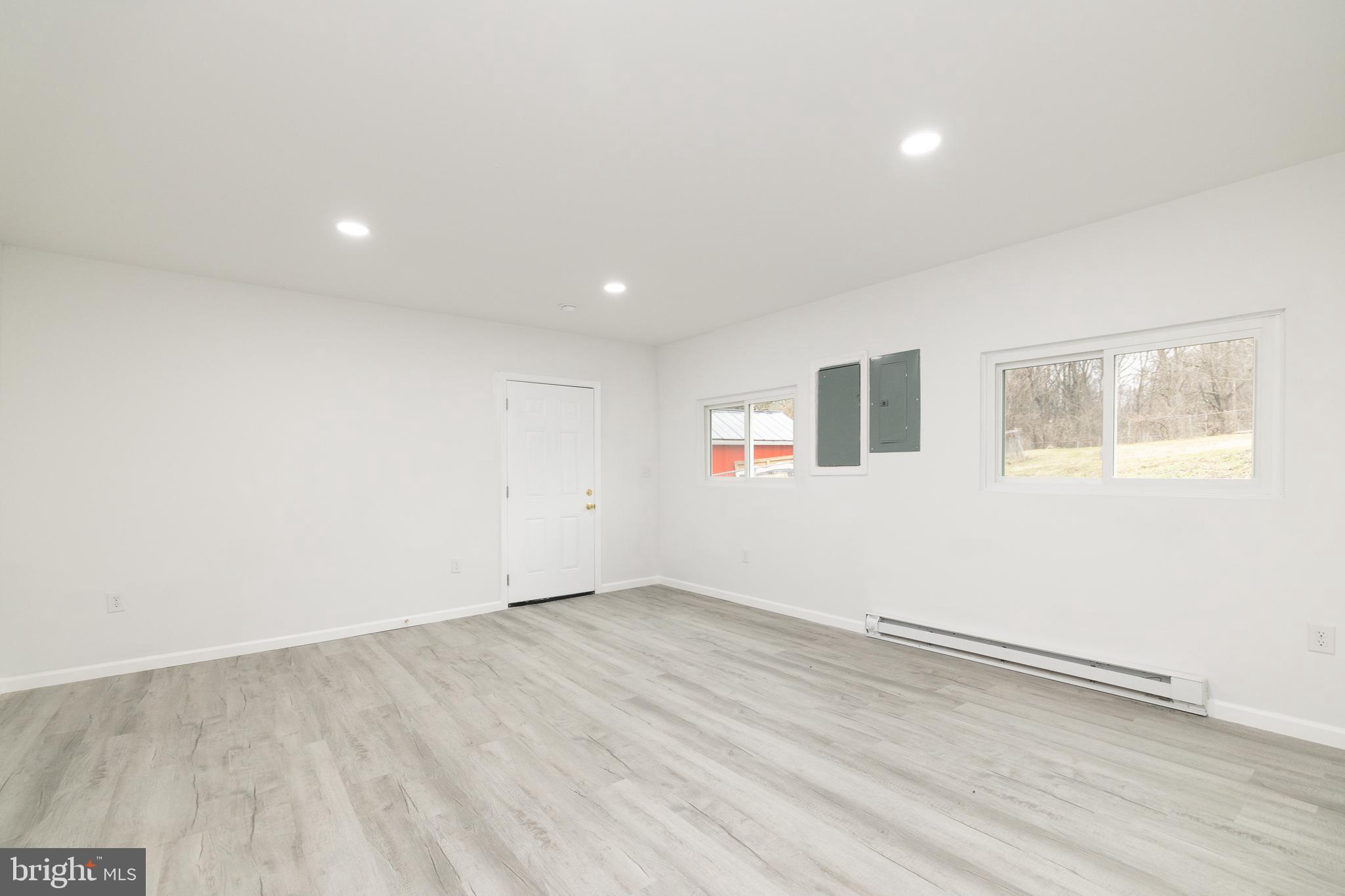6731 Middle Road Middletown, VA 22645 - Photo 27 of 61 an empty room with wooden floor and windows