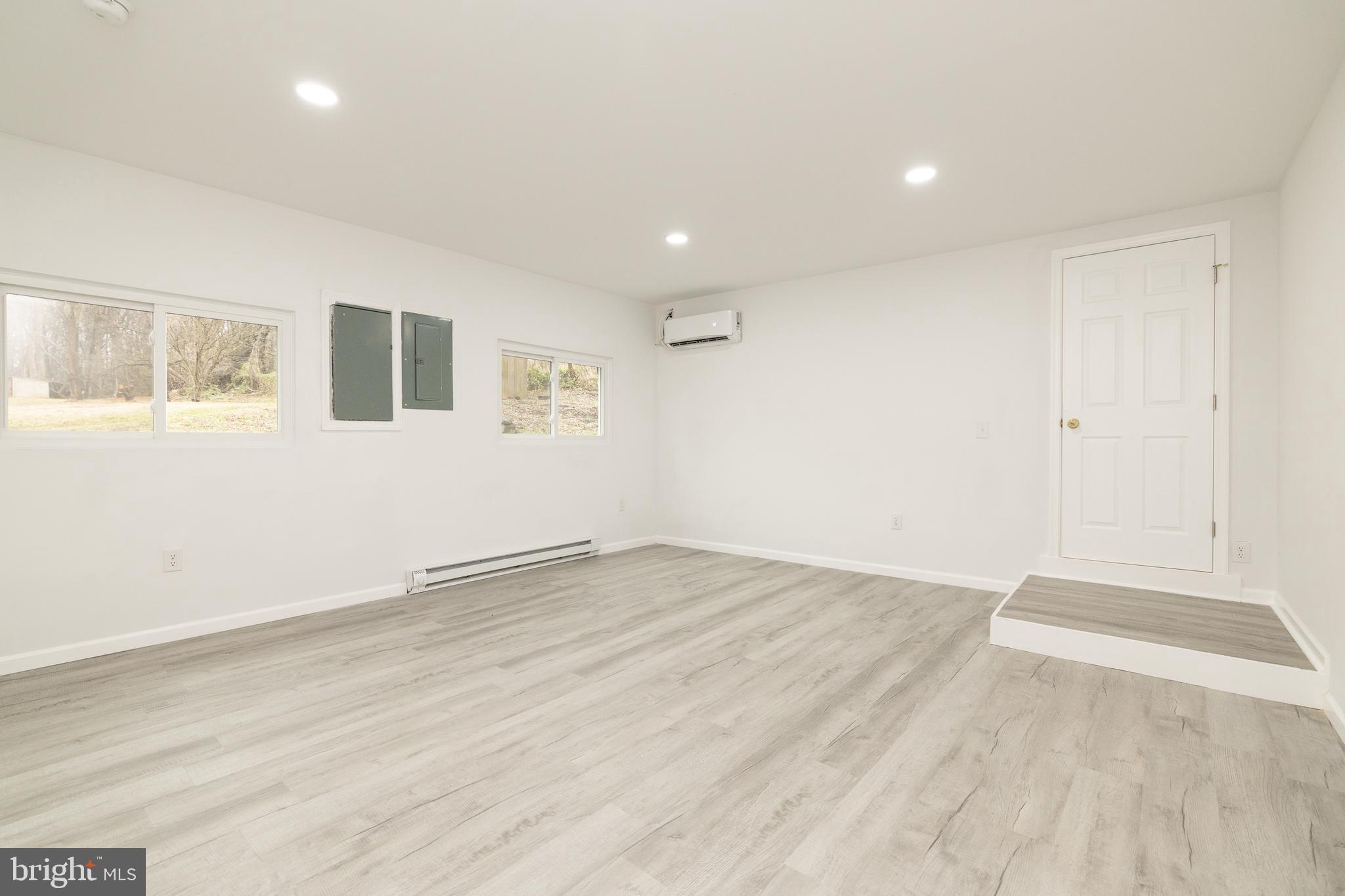 6731 Middle Road Middletown, VA 22645 - Photo 28 of 61 an empty room with wooden floor and windows