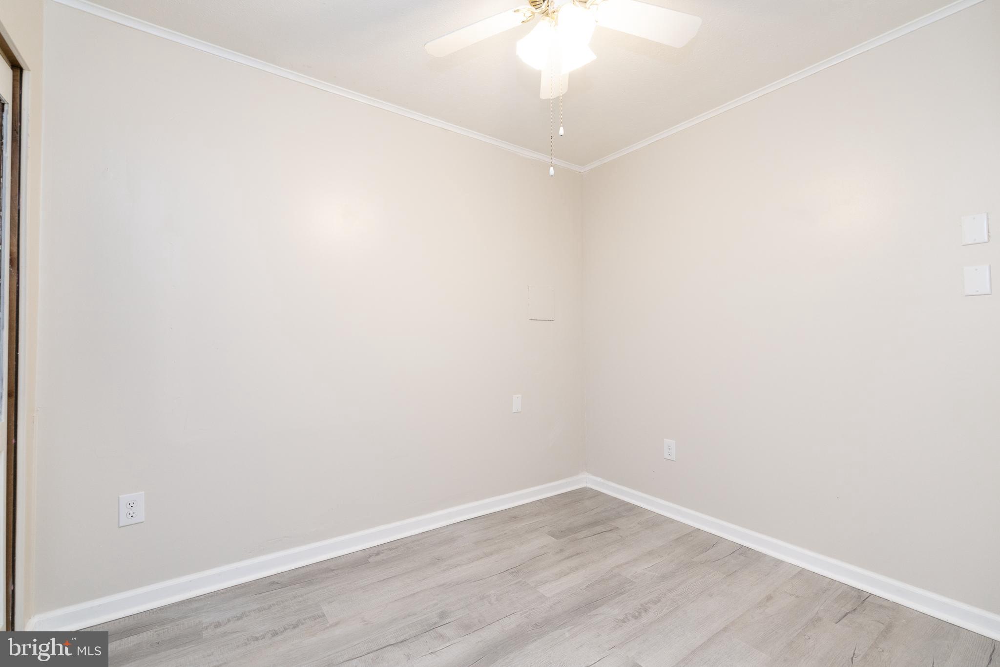 6731 Middle Road Middletown, VA 22645 - Photo 31 of 61 an empty room with wooden floor and fan