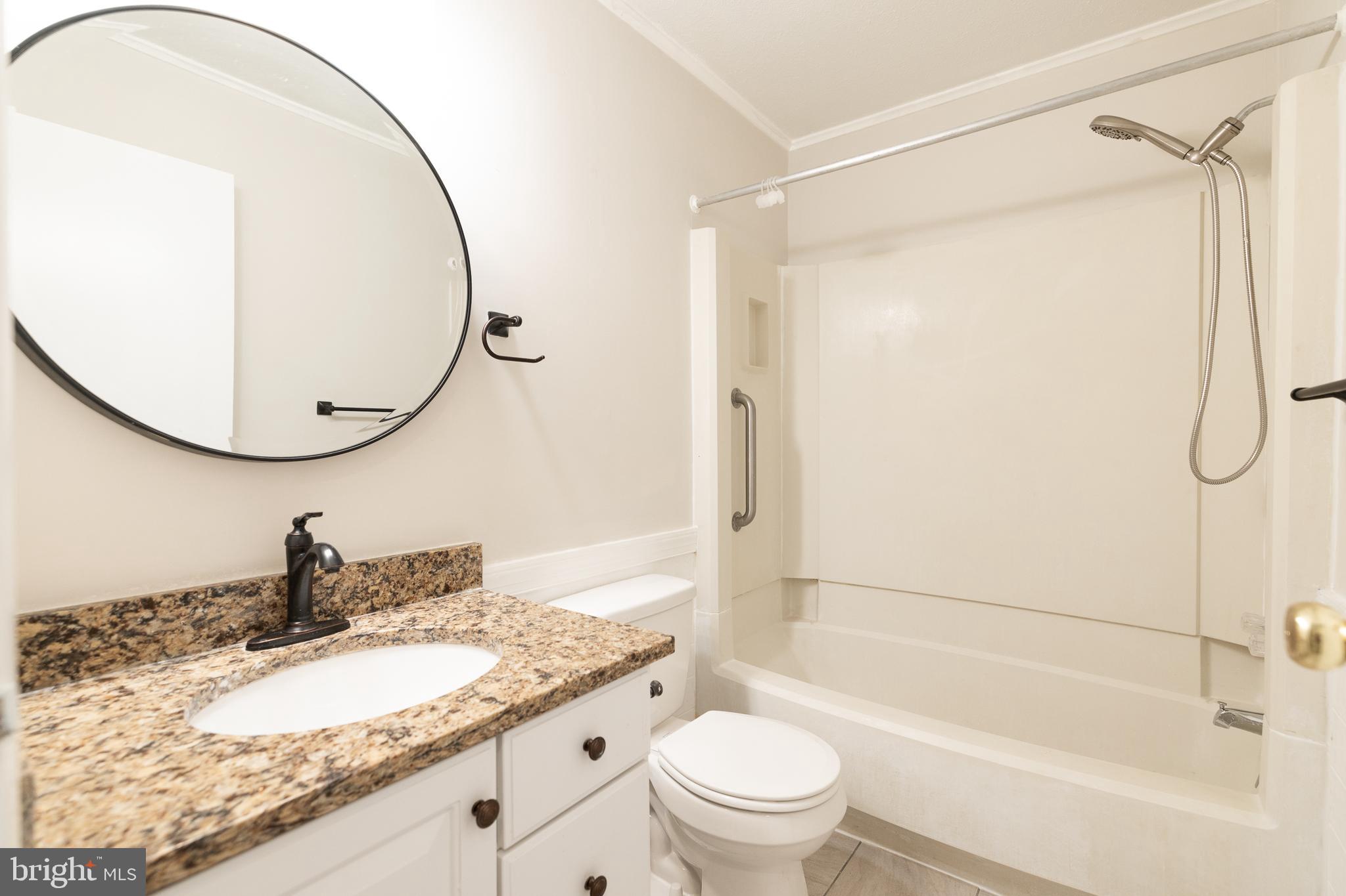 6731 Middle Road Middletown, VA 22645 - Photo 34 of 61 a bathroom with a granite countertop sink mirror toilet and bathtub