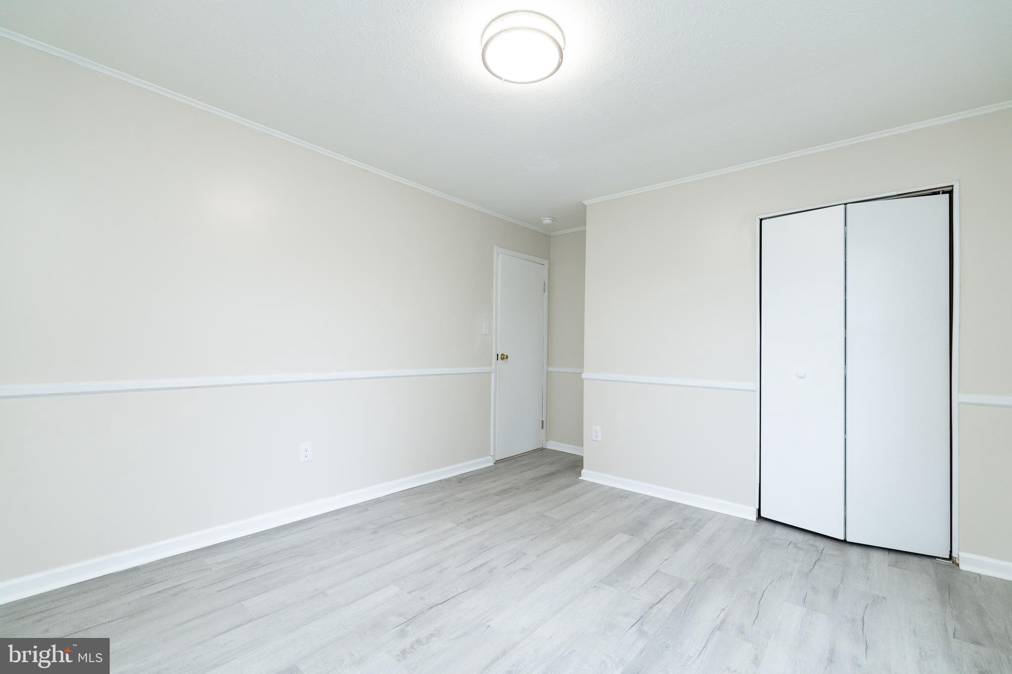 6731 Middle Road Middletown, VA 22645 - Photo 37 of 61 an empty room with wooden floor and white walls