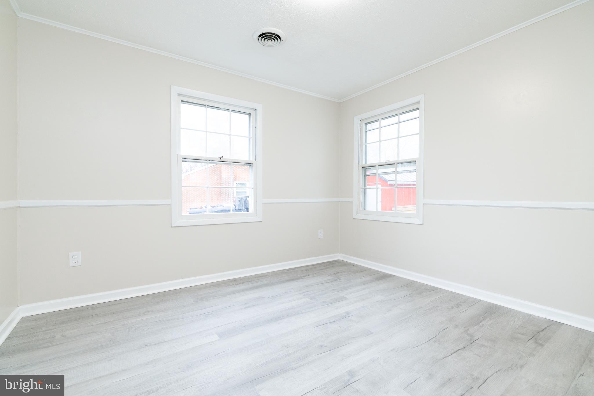 6731 Middle Road Middletown, VA 22645 - Photo 39 of 61 an empty room with wooden floor and windows