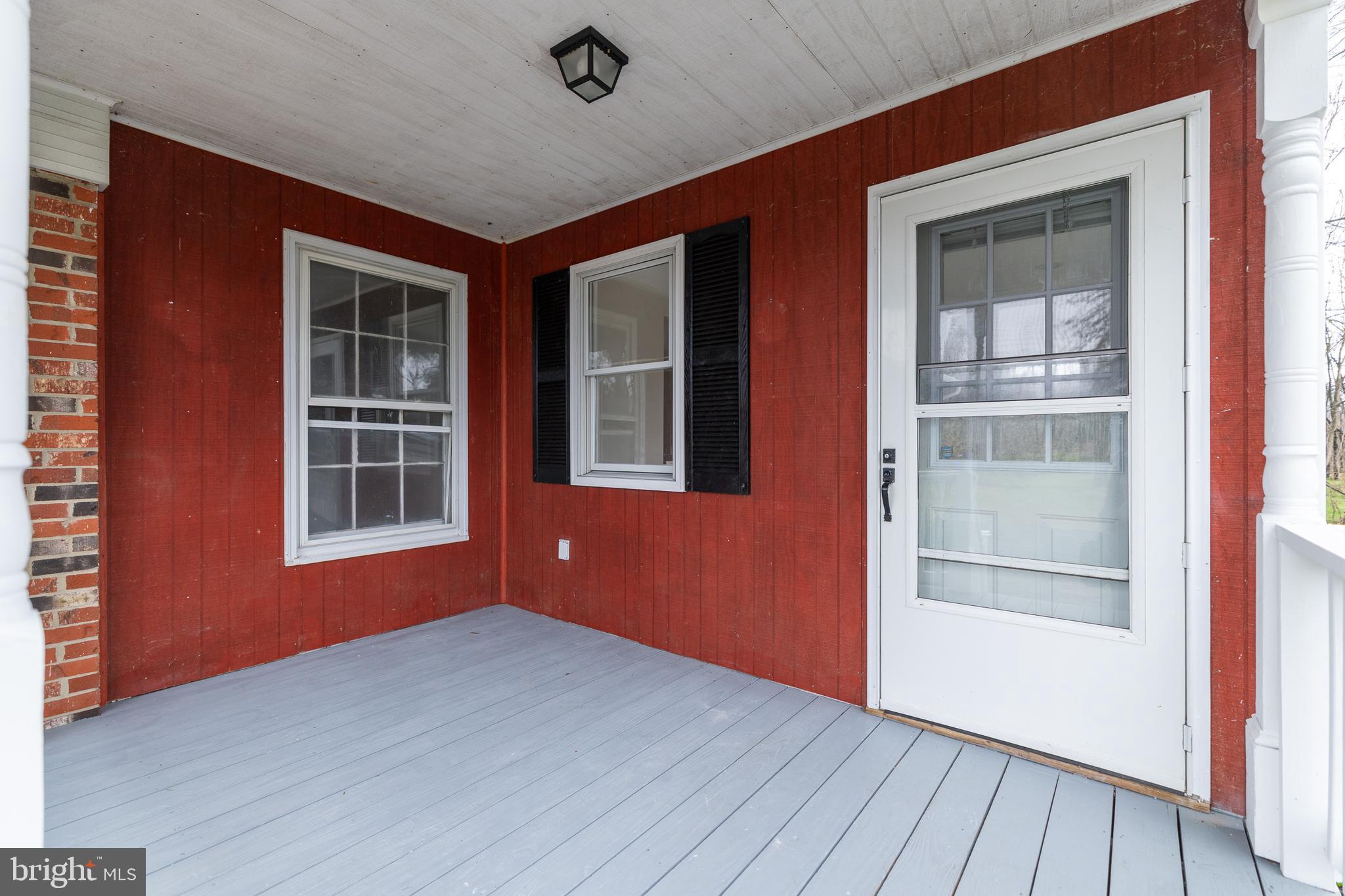 6731 Middle Road Middletown, VA 22645 - Photo 8 of 61 an empty room with wooden floor and windows