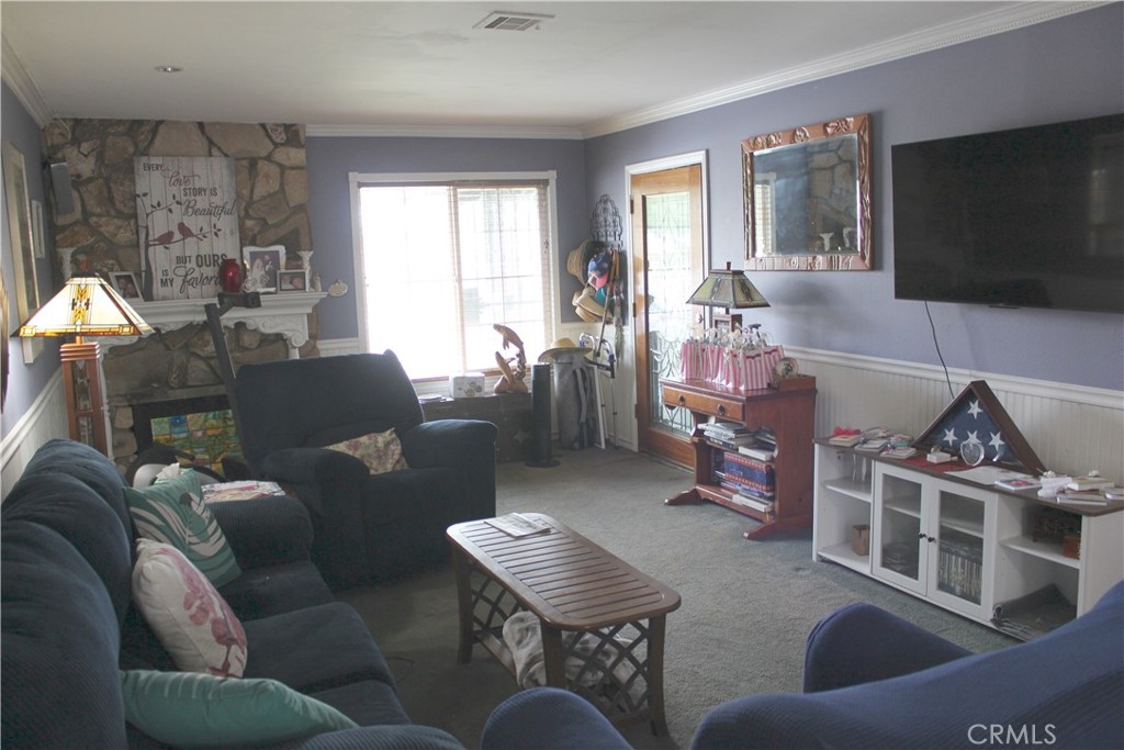 5911 Green Valley Road Riverside, CA 92504 - Photo 3 of 24 a living room with furniture and a flat screen tv