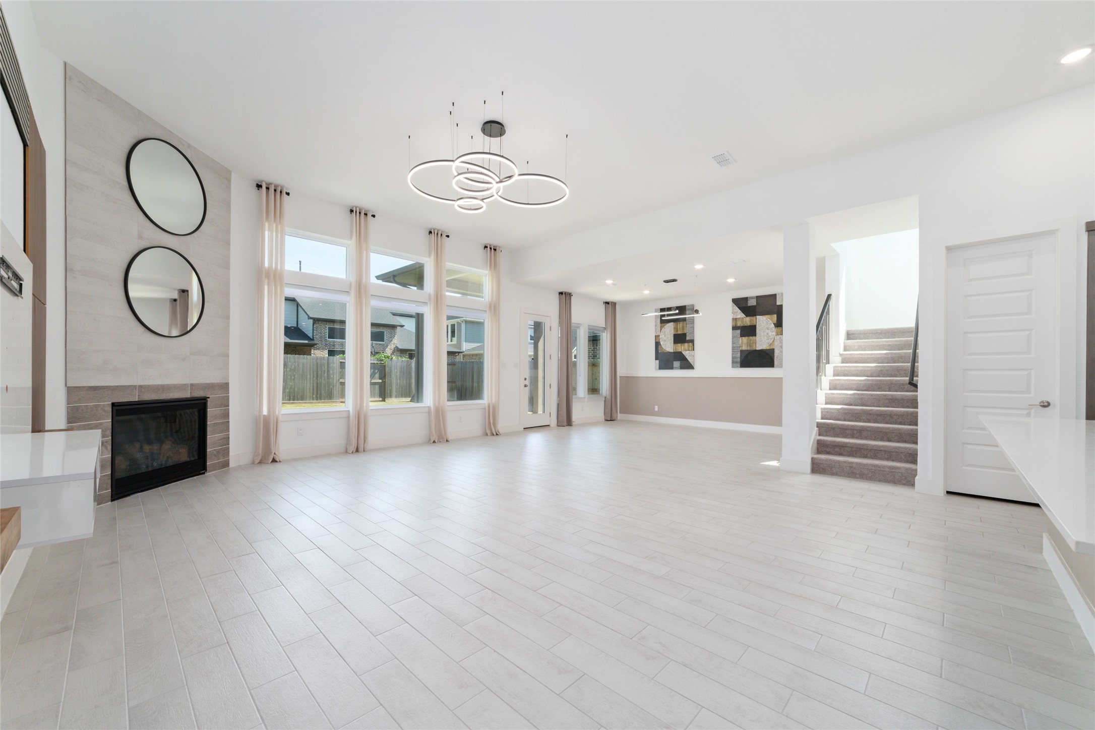 32018 Crested Knl Court Fulshear, TX 77441 - Photo 21 of 49 a view of a room with furniture wooden floor fireplace and windows