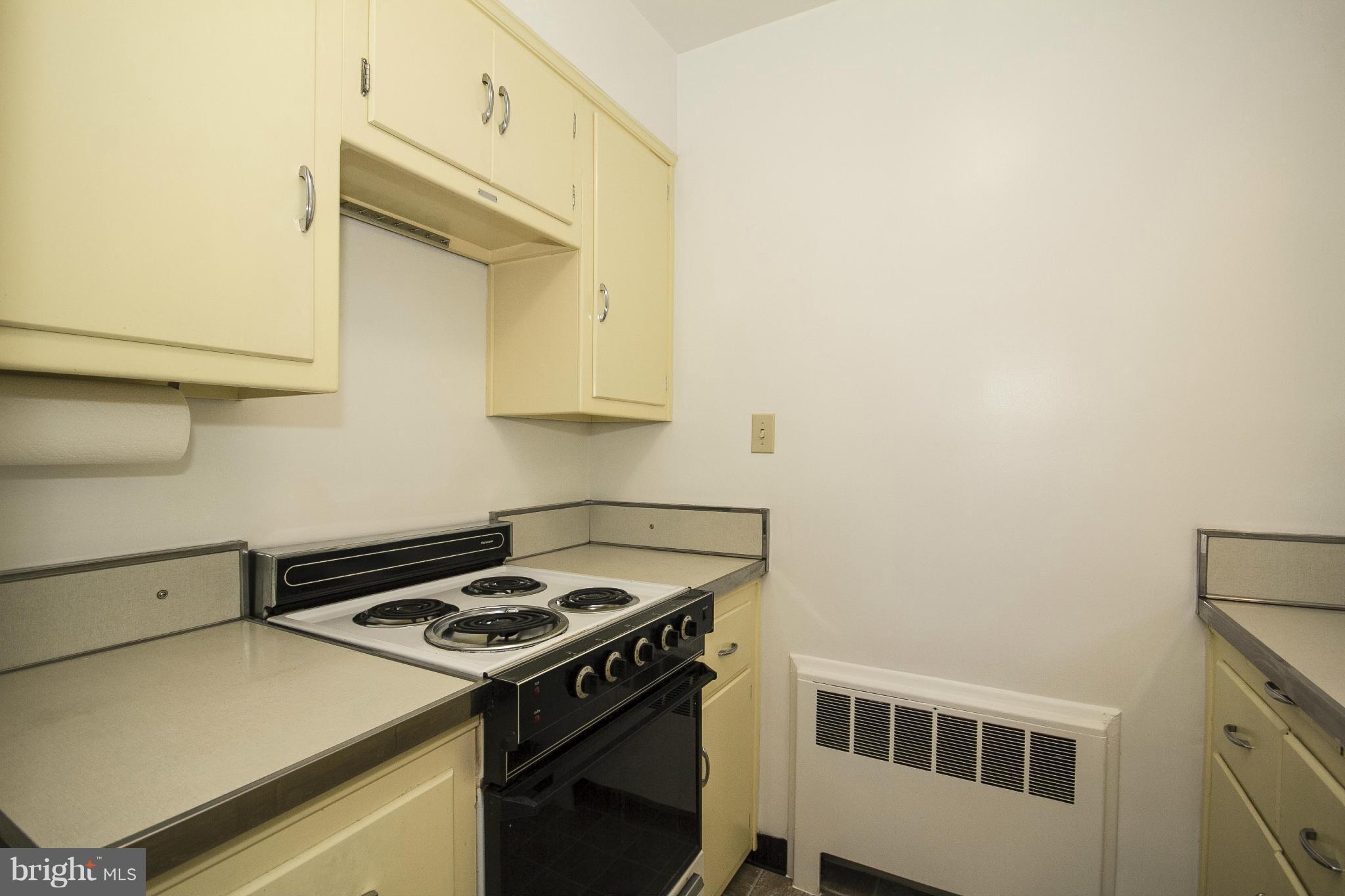 4113 Raleigh Road Baltimore, MD 21207 - Photo 11 of 23 a kitchen with a stove and a microwave