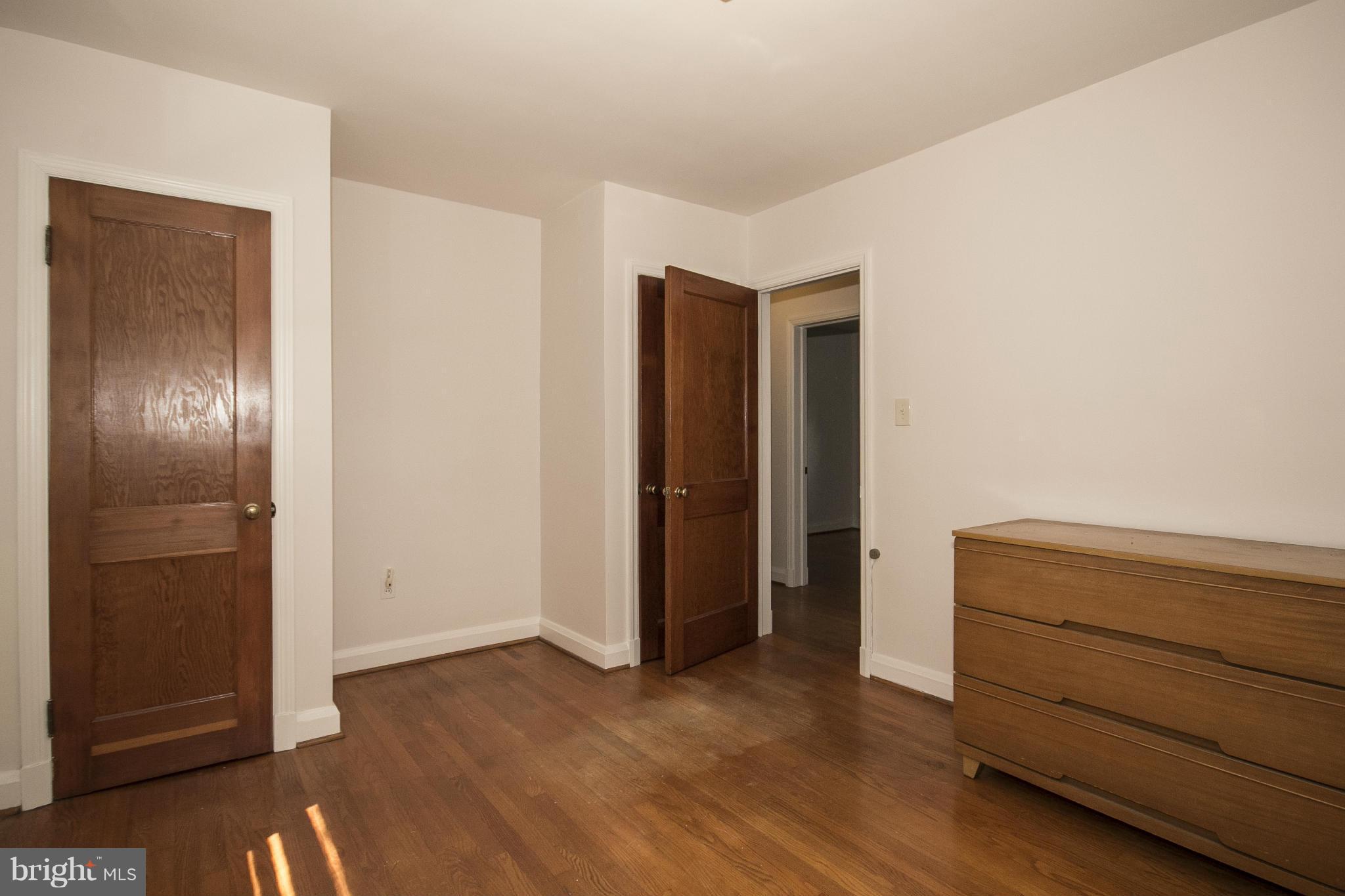 4113 Raleigh Road Baltimore, MD 21207 - Photo 18 of 23 a view of an empty room and closet with wooden floor