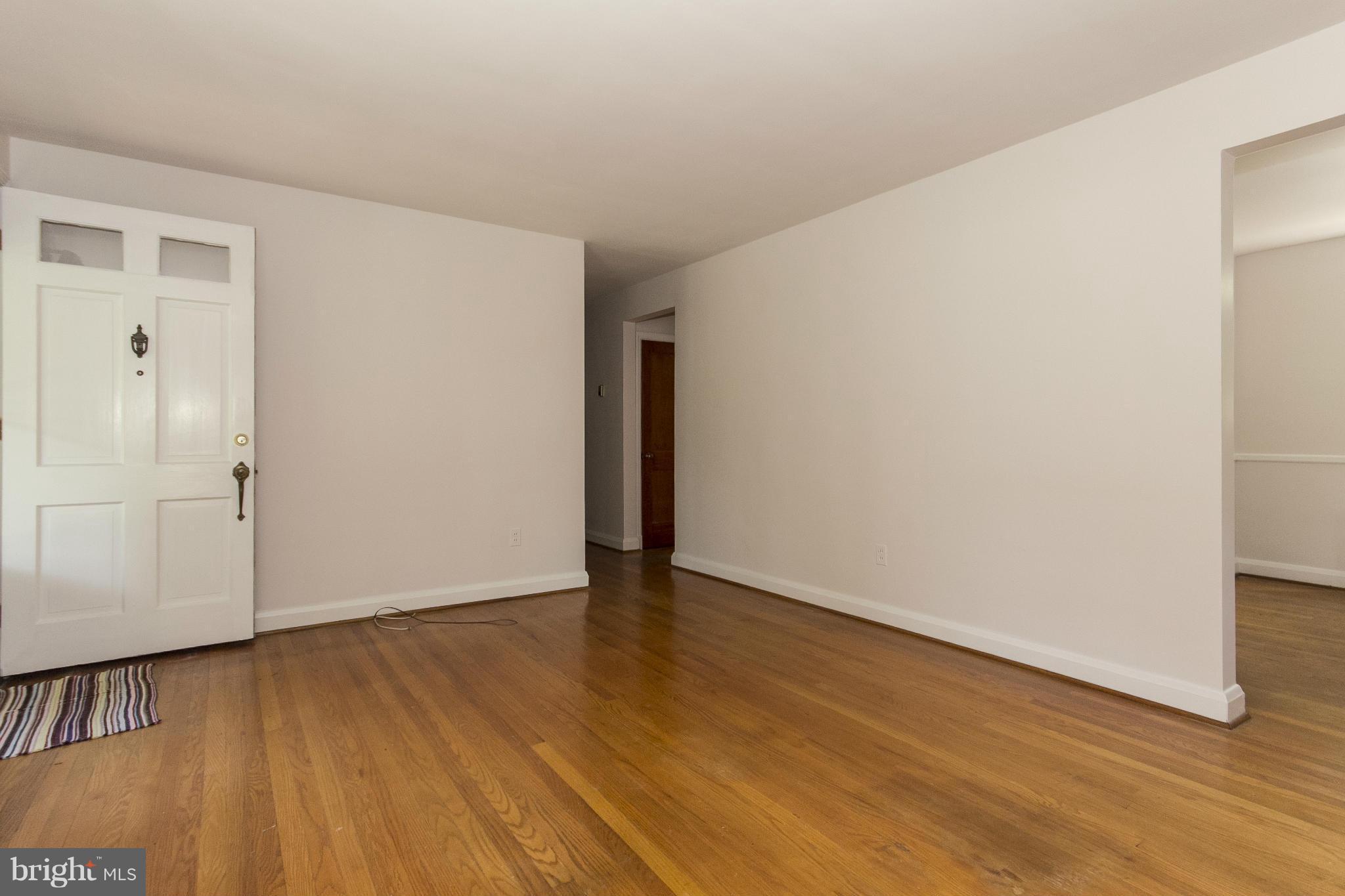 4113 Raleigh Road Baltimore, MD 21207 - Photo 7 of 23 a view of an empty room with wooden floor