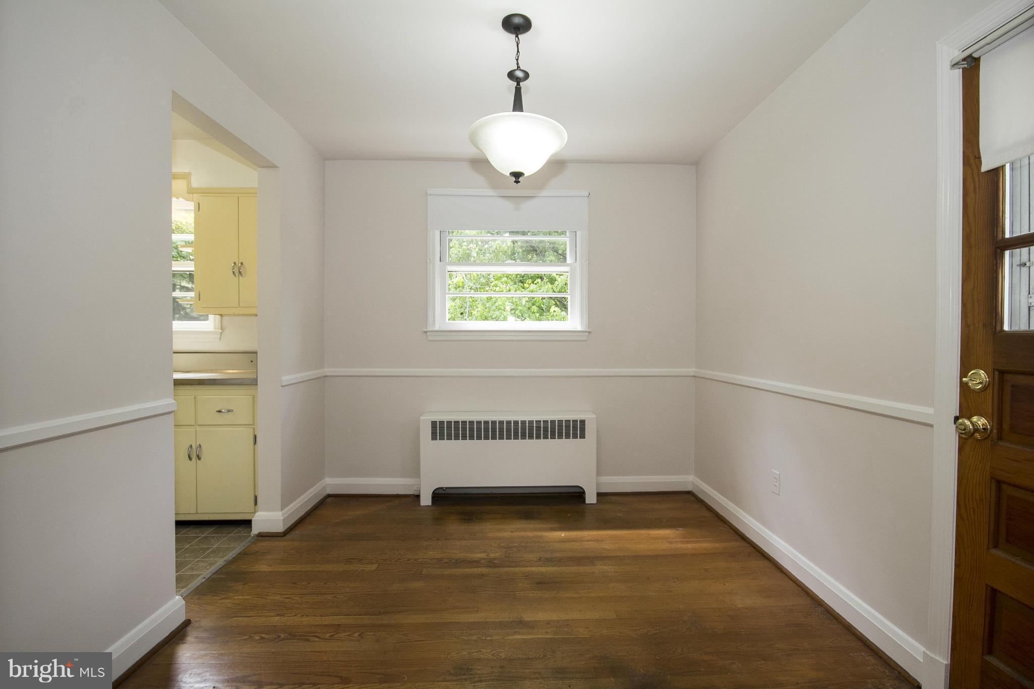 4113 Raleigh Road Baltimore, MD 21207 - Photo 9 of 23 a view of room with window and hardwood floor