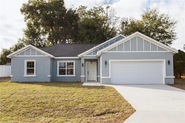 a front view of a house with yard and garage
