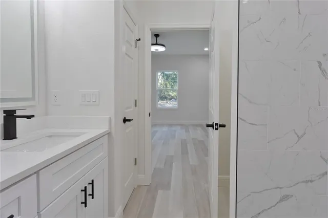 a bathroom with a shower and a sink