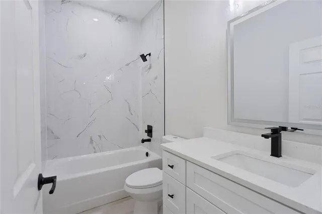 a bathroom with a sink a toilet and a bathtub