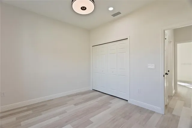 an empty room with wooden floor