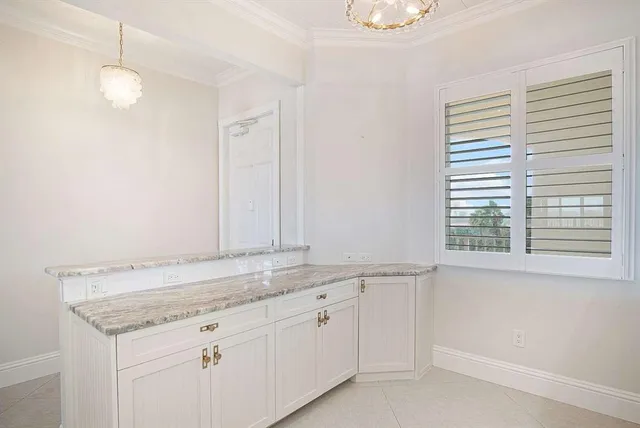 a kitchen with stainless steel appliances white cabinets and a microwave oven