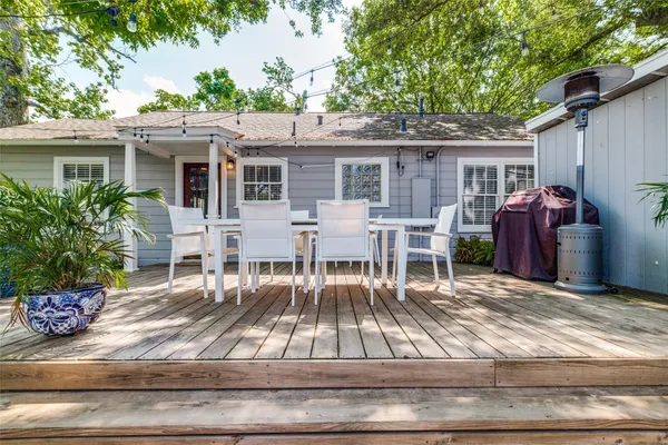a view of a house with a yard and a patio