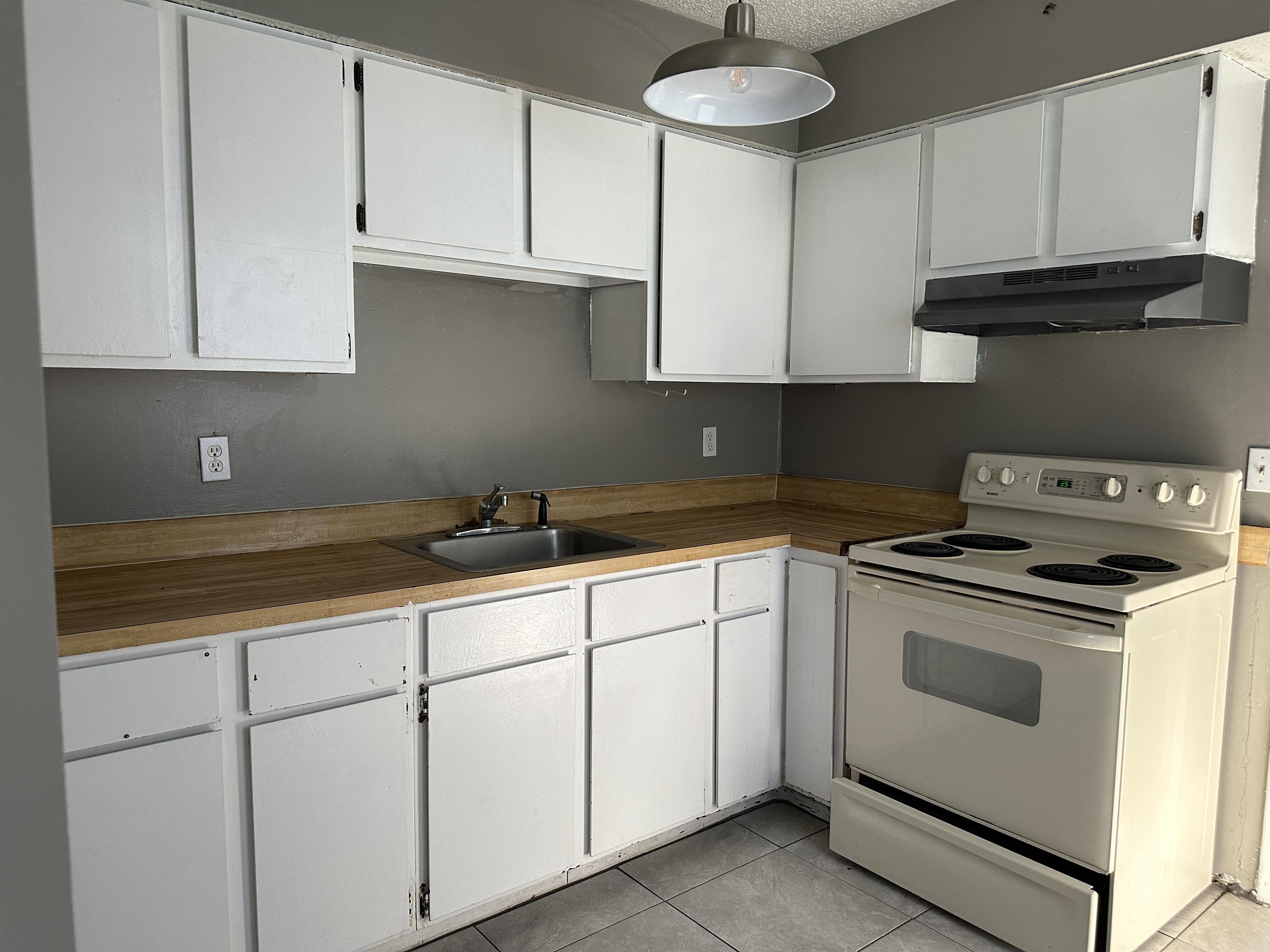 3661 A1A South St. Augustine, FL 32080 - Photo 3 of 8 a kitchen with granite countertop white cabinets and white stainless steel appliances