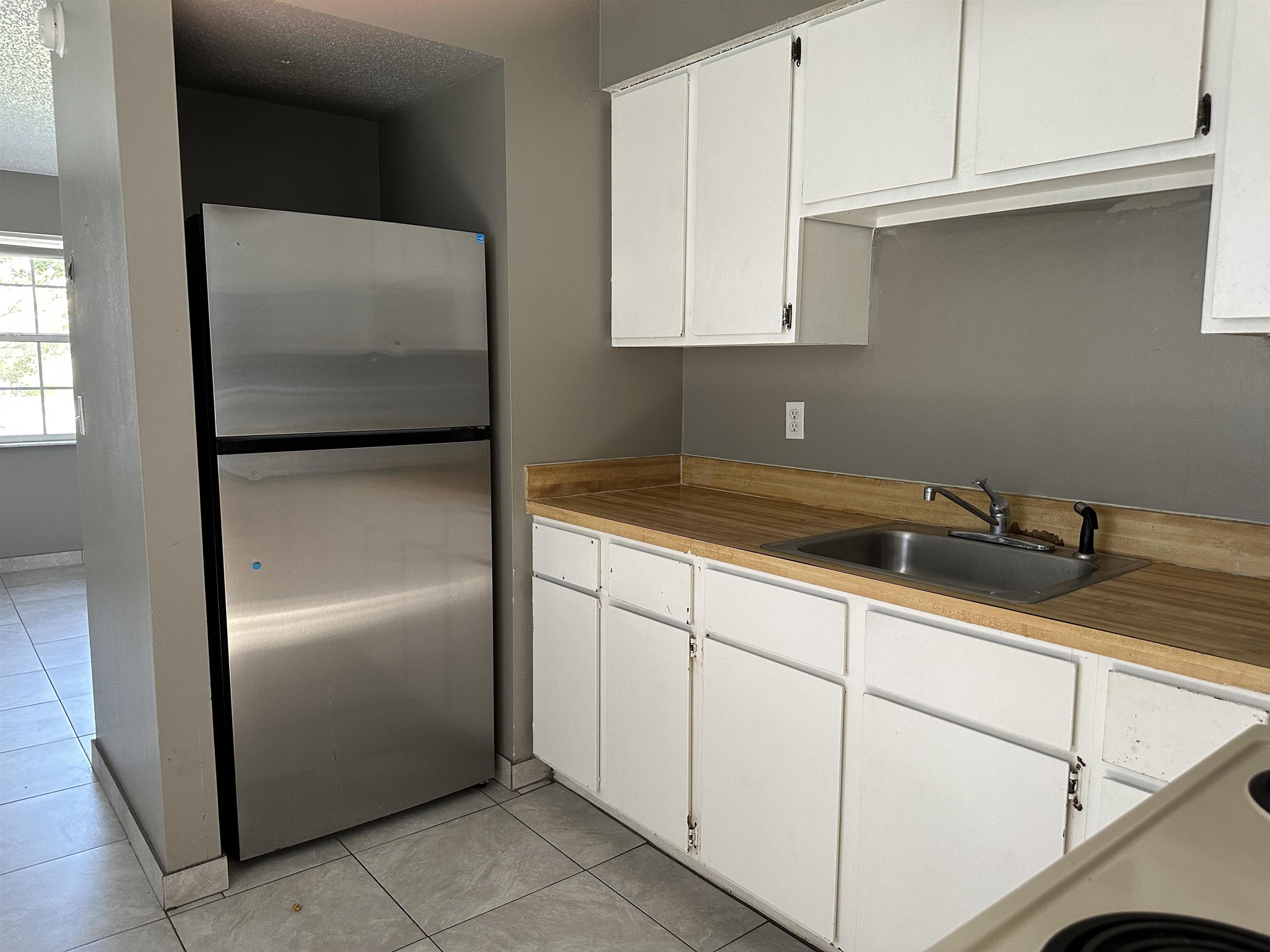 3661 A1A South St. Augustine, FL 32080 - Photo 4 of 8 a kitchen with stainless steel appliances white cabinets and a refrigerator