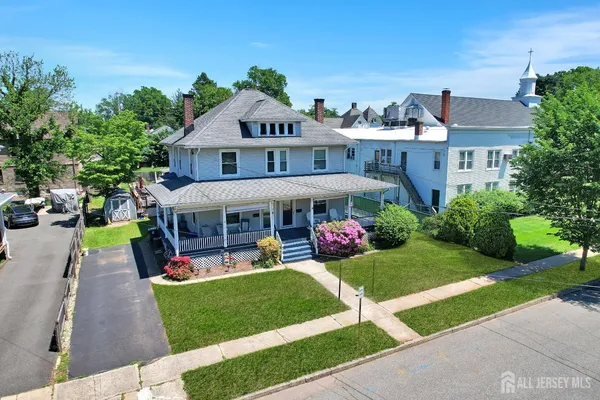 a view of a house with a yard and sitting area