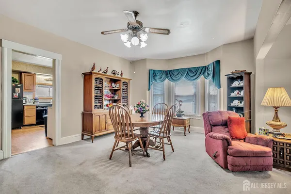 a dining room with furniture and wooden floor
