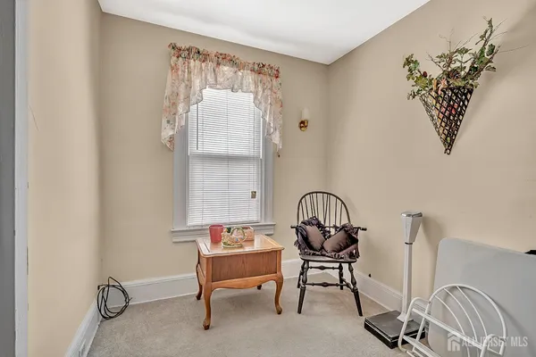 a view of a workspace room with furniture and wooden floor