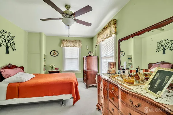 a bedroom with 2 bed and a chandelier