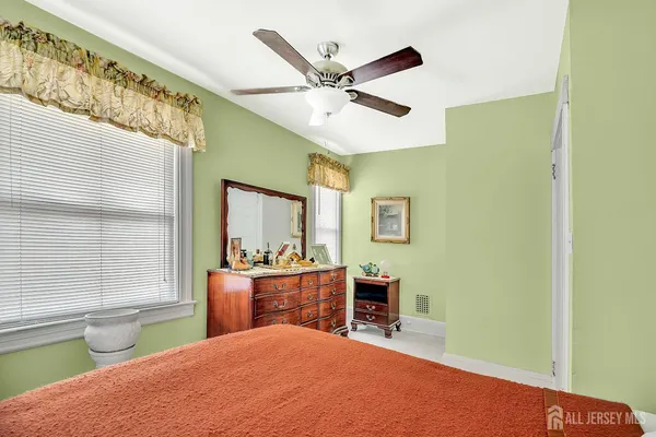 a bedroom with a bed and a desk