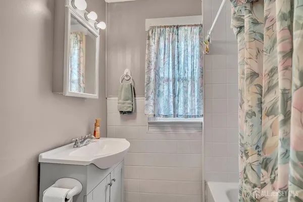 a bathroom with a sink vanity granite and a mirror