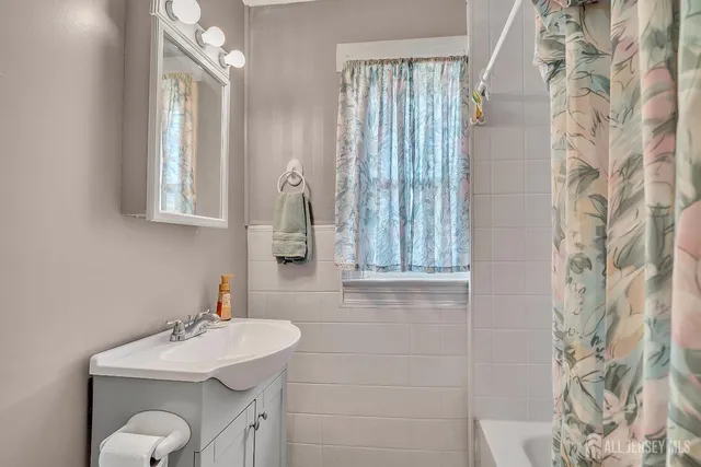a bathroom with a sink vanity granite and a mirror