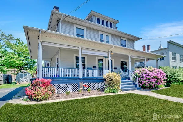 a front view of a house with a garden and deck