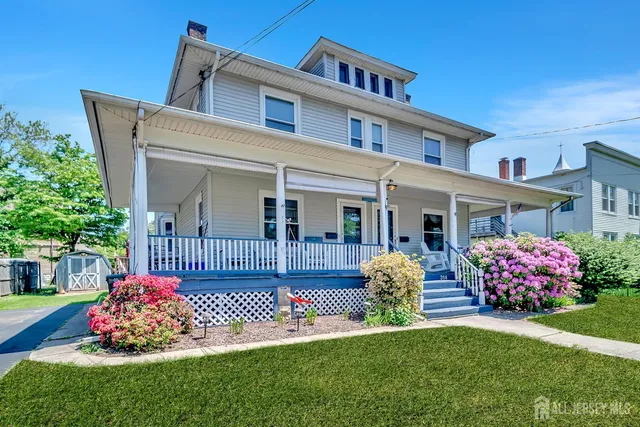 a front view of a house with a garden and deck