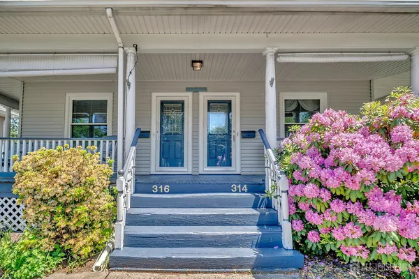 a front view of a house with flowers