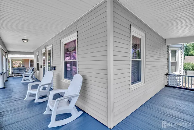 a view of a porch with furniture and wooden floor