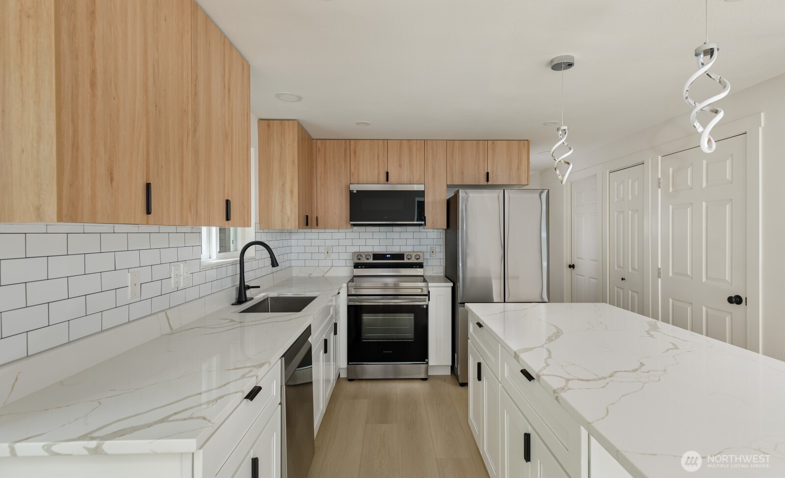 7605 Northeast Hidden Cove Road Bainbridge Island, WA 98110 - Photo 30 of 36 a kitchen with a sink a stove and refrigerator