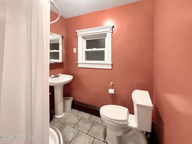 a white toilet sitting next to a bathroom sink