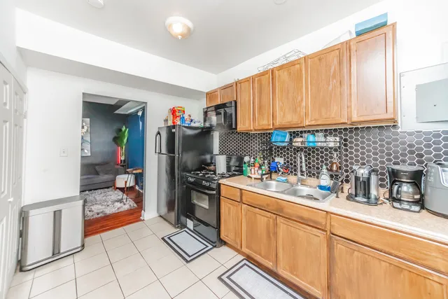 a kitchen with stainless steel appliances granite countertop a stove and cabinets
