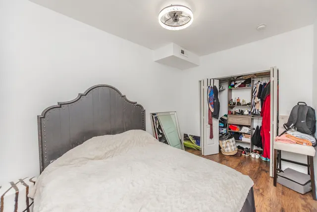 a bedroom with a bed and a chandelier