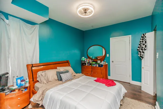 a bedroom with a bed and a mirror