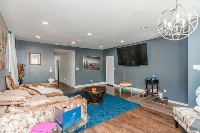a bedroom with furniture and a flat screen tv