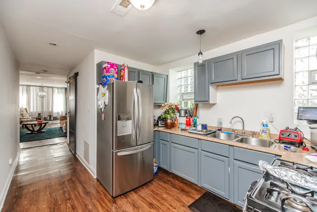 a kitchen view with granite countertop a sink appliances and cabinets
