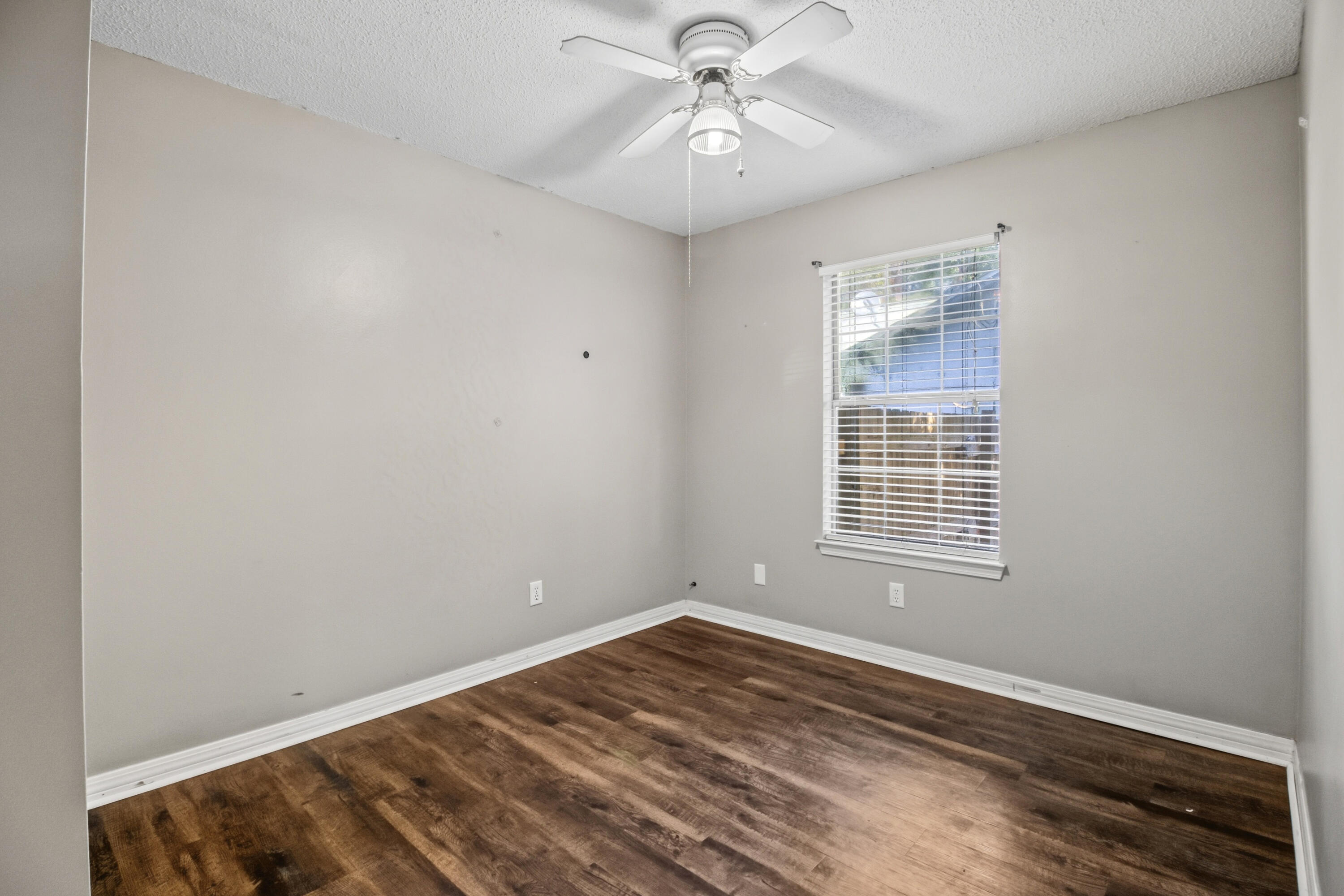 3014 Windsor Circle Crestview, FL 32539 - Photo 8 of 26 a view of empty room with wooden floor and fan